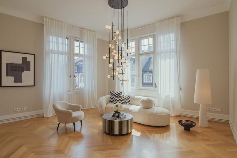 Picture after furnishing the model apartment. An elegant modern domestic room with luxurious flooring and an electric lamp, seen through a window in a home interior. This indoor apartment exudes sophistication and style.